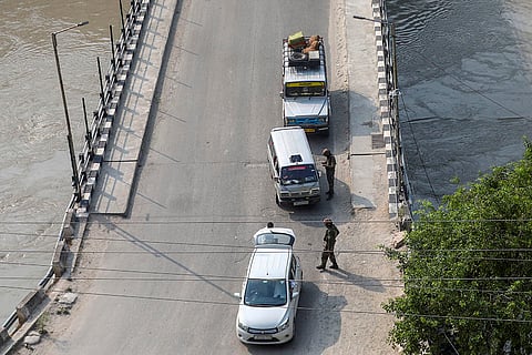 Security personnel check a vehicle in Doda